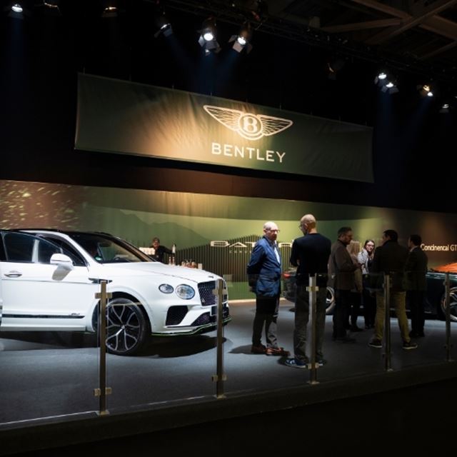 Photo of a luxurious booth at a trade show dedicated to modern supercars