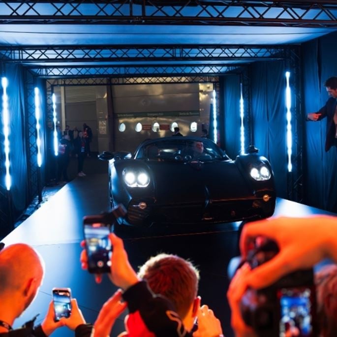 Lots of people taking photos of the car arriving on stage