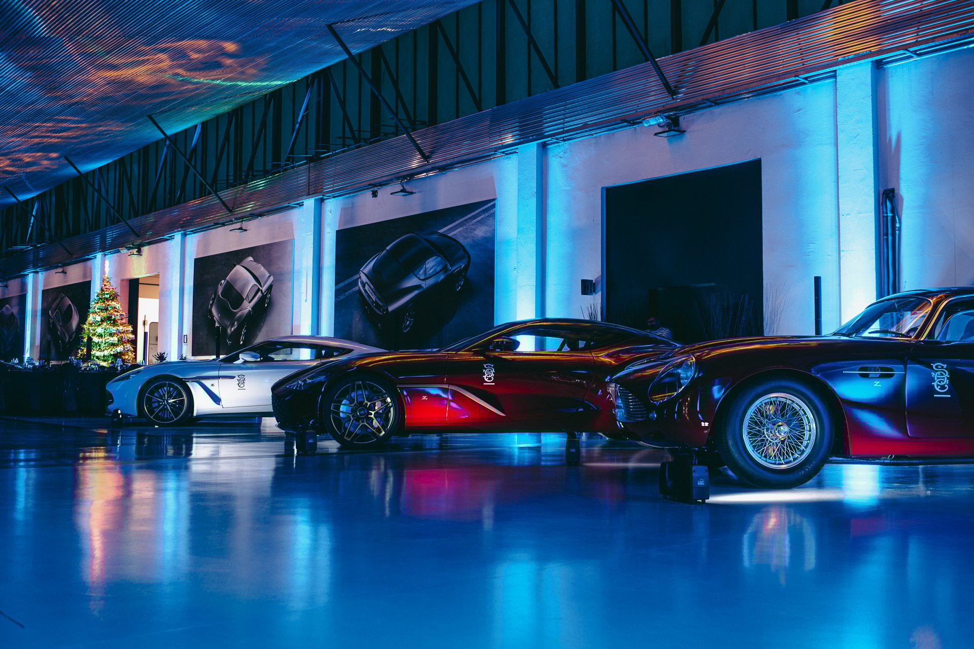 garage with blue neon lights displaying supercars